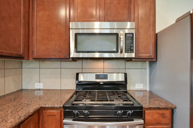 a stove top oven sitting inside of a kitchen