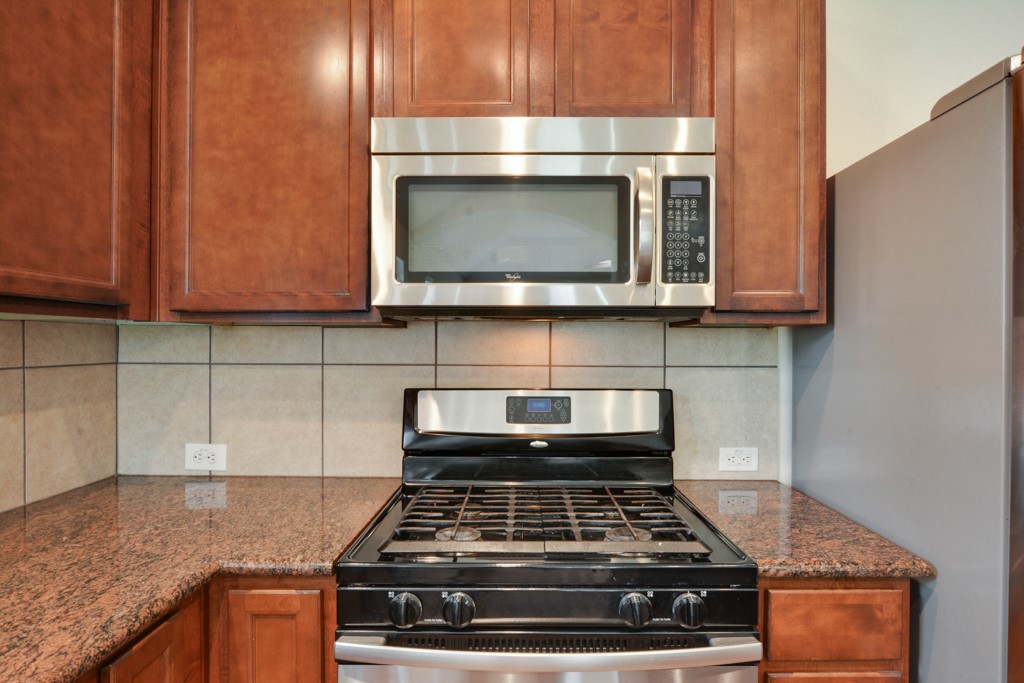 291 Cold Spring Buda, TX 78610 - Photo 7 of 25 a stove top oven sitting inside of a kitchen
