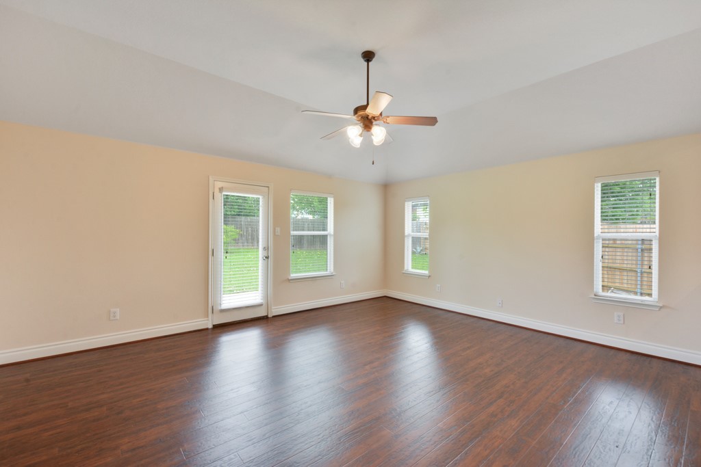 291 Cold Spring Buda, TX 78610 - Photo 10 of 25 a view of an empty room with wooden floor and a window