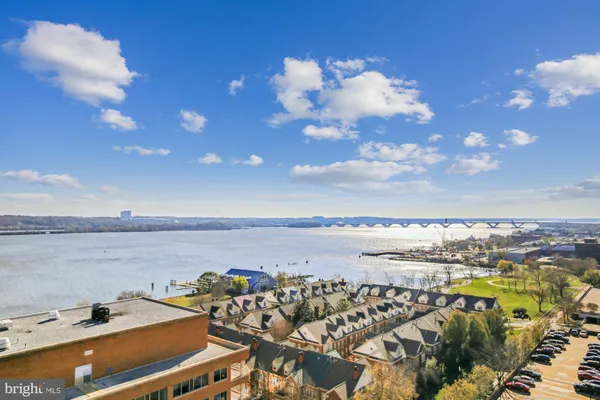 a view with granite countertop kitchen island a sink and a refrigerator