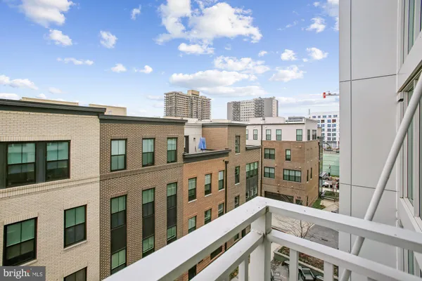 a view of a balcony with dining table & chairs
