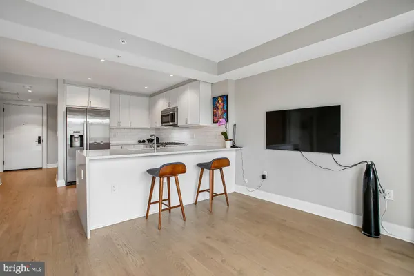 a kitchen with a sink and steel appliances