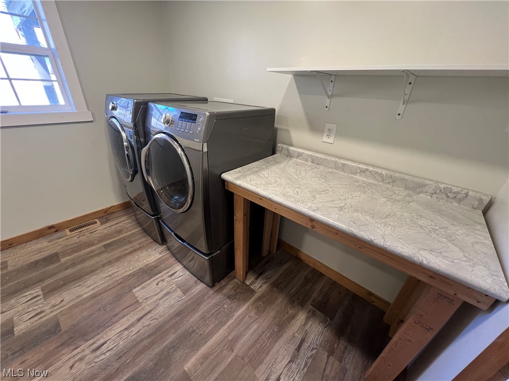 6544 Middle Run Road Dover, OH 44622 - Photo 20 of 47 Laundry room featuring dark wood-type flooring and separate washer and dryer