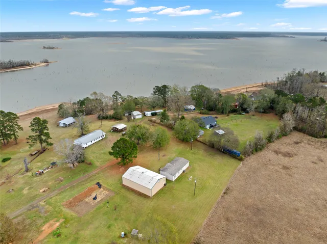 an aerial view of ocean and houses with outdoor space