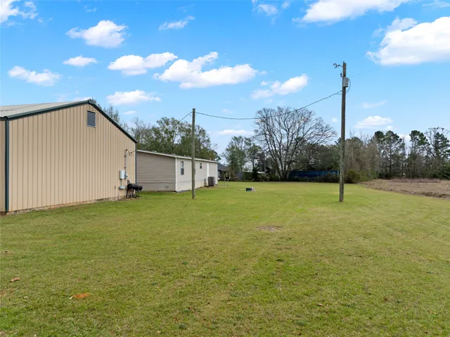 a kitchen with stainless steel appliances granite countertop a refrigerator a sink dishwasher a stove with wooden cabinets and floor