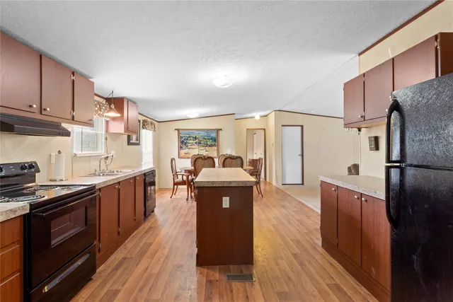 a refrigerator freezer sitting inside of a kitchen