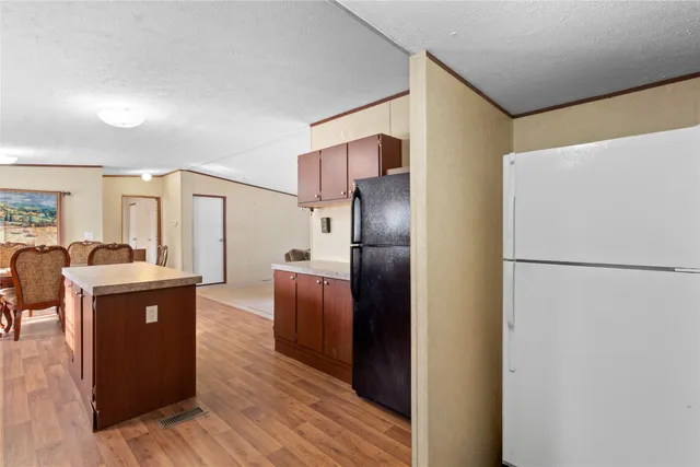 a kitchen with granite countertop wooden cabinets and a stove top oven