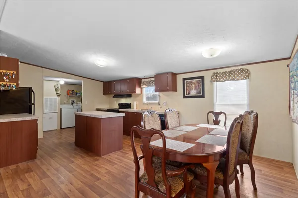 a bed room with furniture a desk and chair with wooden floor