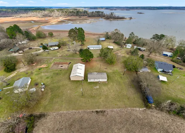 an aerial view of a houses with a lake view