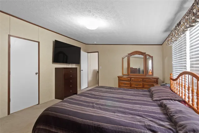 a bedroom with bed and a closet