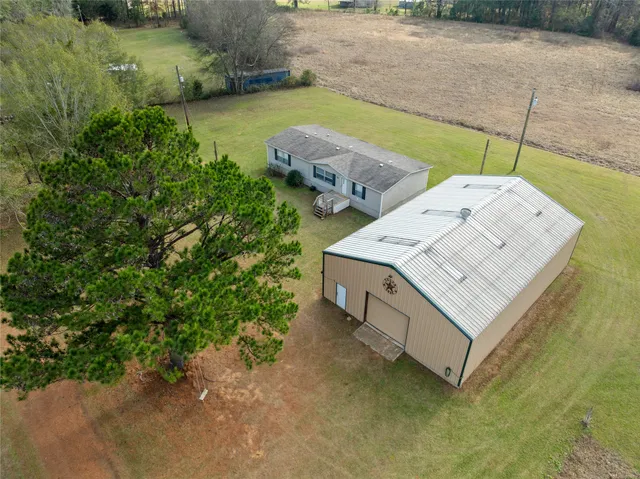 a view of a house with a yard and sitting area