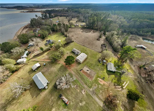 an aerial view of a house with a yard