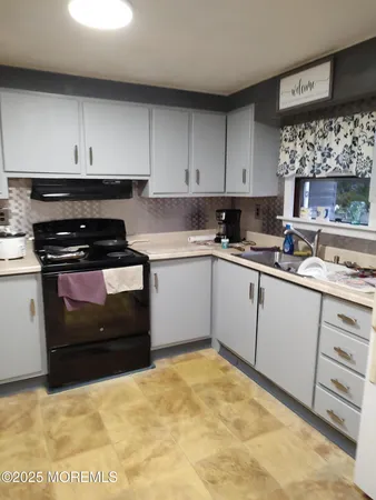 a kitchen with a sink and cabinets