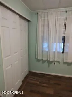 a view of a room with wooden floor and windows