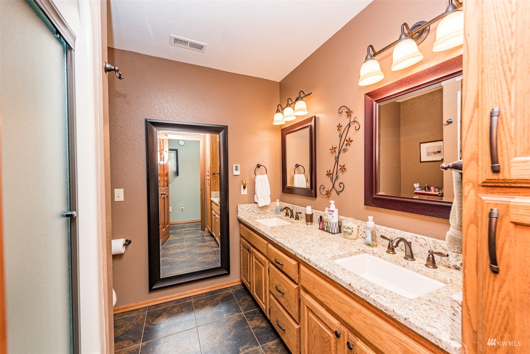 1313 Doe Run Road Sequim, WA 98382 - Photo 27 of 40 a bathroom with a double vanity sink and a mirror