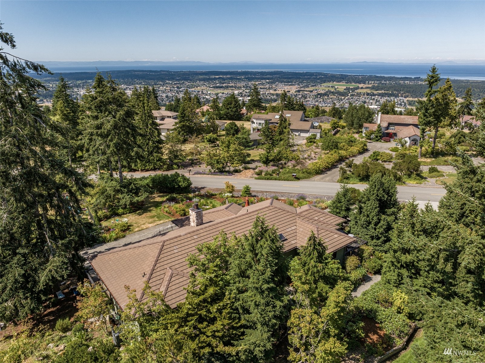 1313 Doe Run Road Sequim, WA 98382 - Photo 36 of 40 an aerial view of residential houses with outdoor space and trees