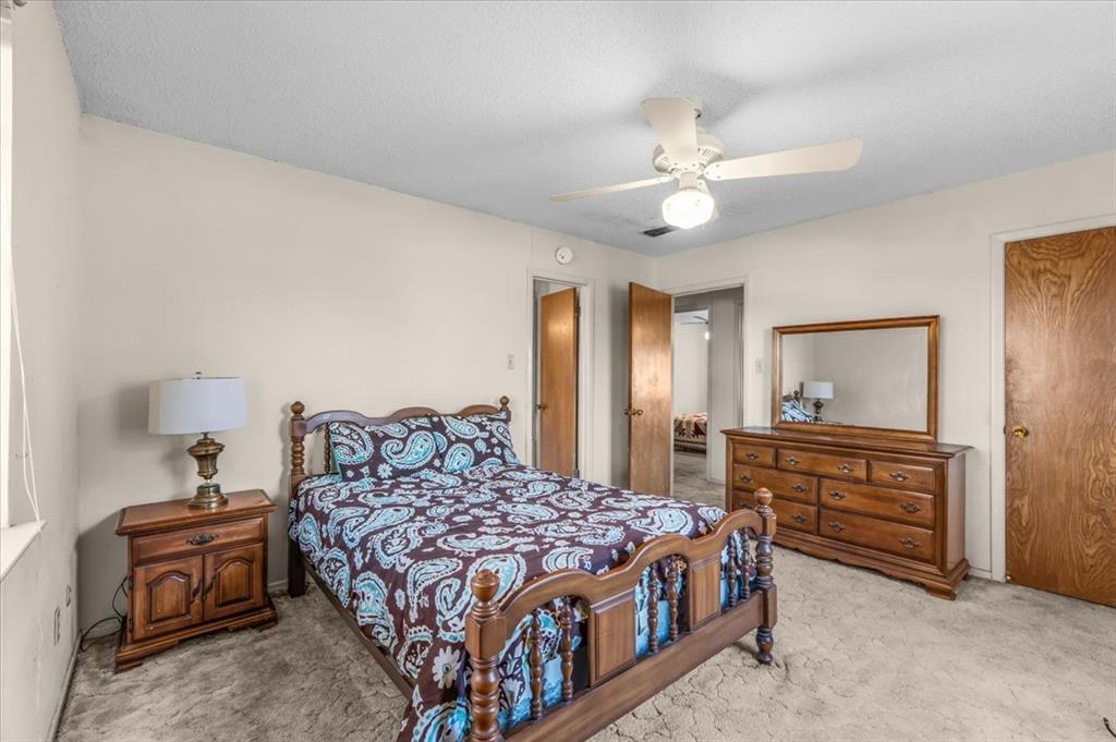 601 State Street Weatherford, TX 76086 - Photo 21 of 38 a bedroom with a bed and wooden floor