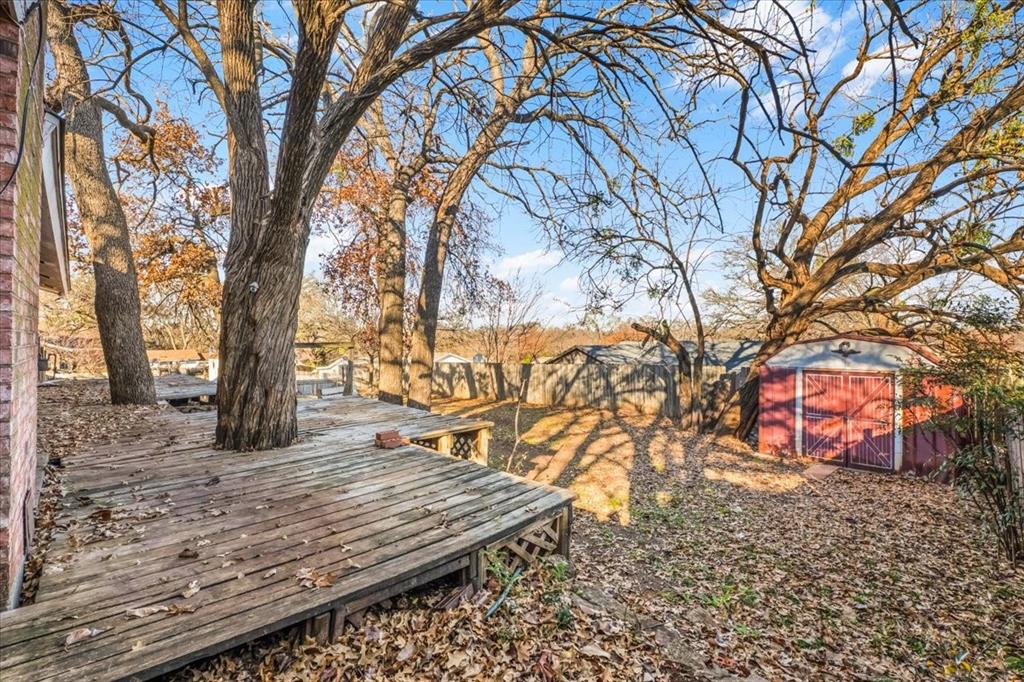 601 State Street Weatherford, TX 76086 - Photo 23 of 38 a view of a backyard with wooden fence and large trees