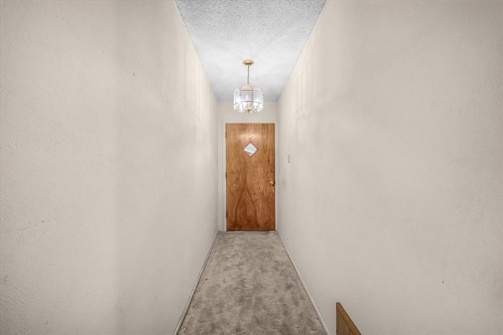 601 State Street Weatherford, TX 76086 - Photo 4 of 38 a view of a hallway with wooden floor and door