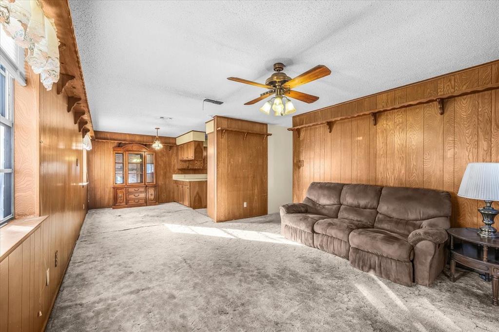 601 State Street Weatherford, TX 76086 - Photo 7 of 38 a living room with furniture and a chandelier