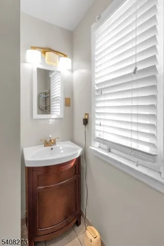 a bathroom with a sink a toilet and a window