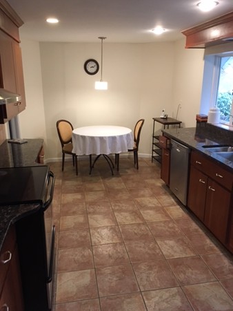 9 West Knoll Road Andover, MA 01810 - Photo 11 of 16 a open kitchen with a table and chairs