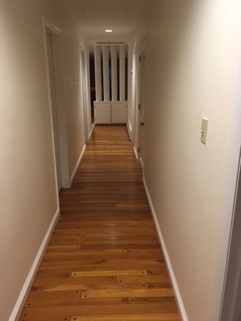 9 West Knoll Road Andover, MA 01810 - Photo 13 of 16 a view of a hallway with wooden floor and staircase