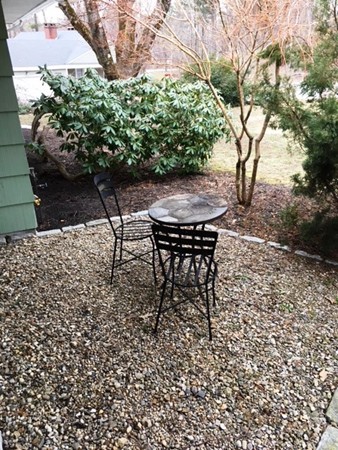 9 West Knoll Road Andover, MA 01810 - Photo 4 of 16 a view of a backyard with table and chairs and potted plants