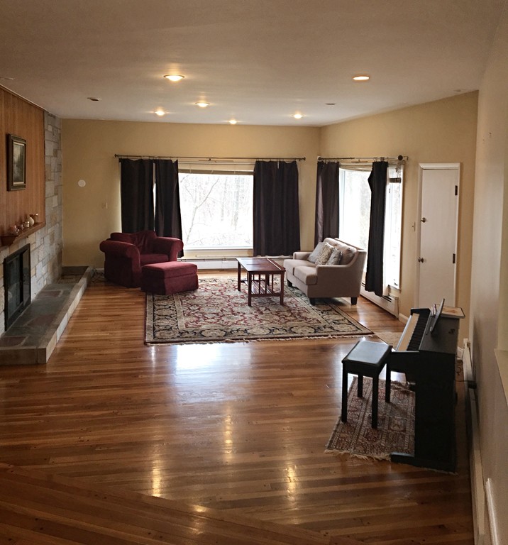 9 West Knoll Road Andover, MA 01810 - Photo 5 of 16 a living room with fireplace furniture and a large window