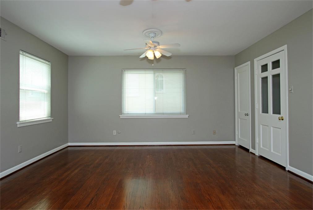 2332 Suffolk Drive Houston, TX 77027 - Photo 12 of 20 a view of an empty room with wooden floor and a window