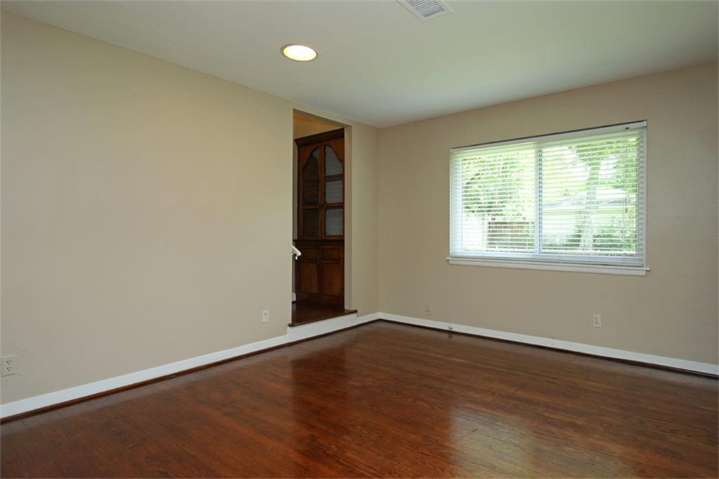 2332 Suffolk Drive Houston, TX 77027 - Photo 15 of 20 a view of an empty room with wooden floor and a window