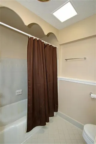 a bathroom with a shower and a toilet