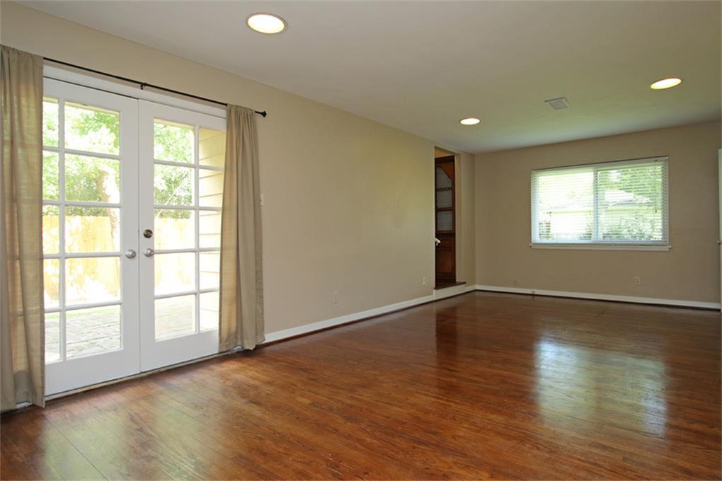 2332 Suffolk Drive Houston, TX 77027 - Photo 2 of 20 a view of an empty room with wooden floor and a window