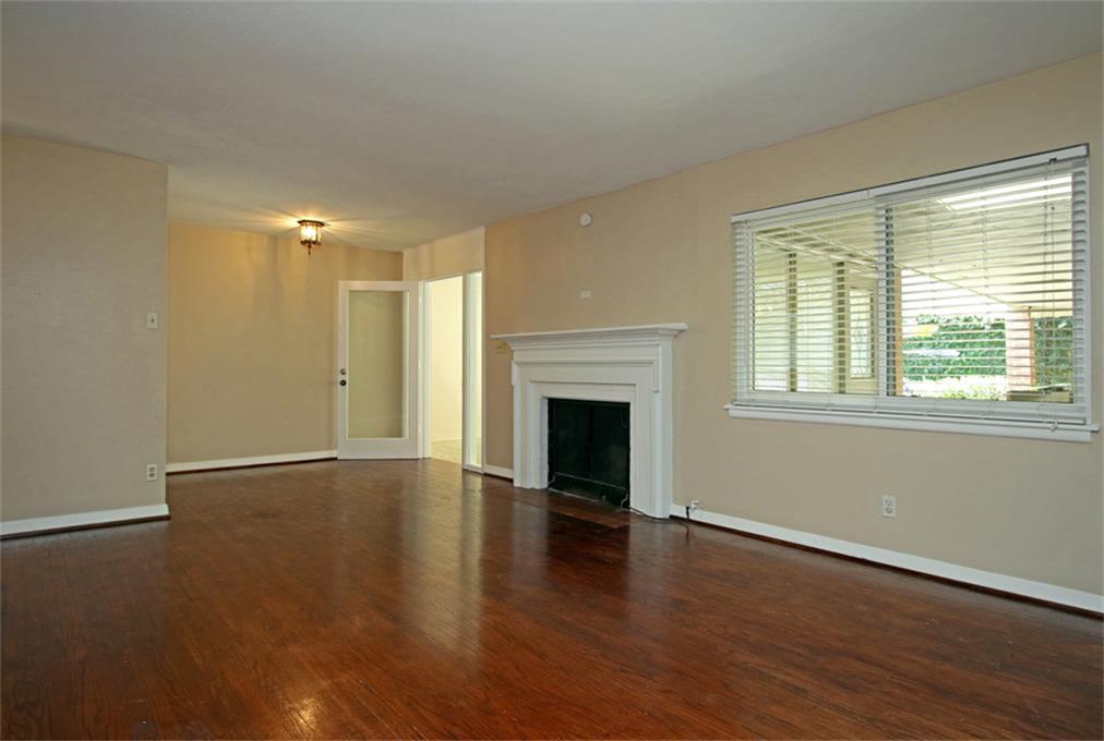 2332 Suffolk Drive Houston, TX 77027 - Photo 3 of 20 a view of an empty room with wooden floor and a window