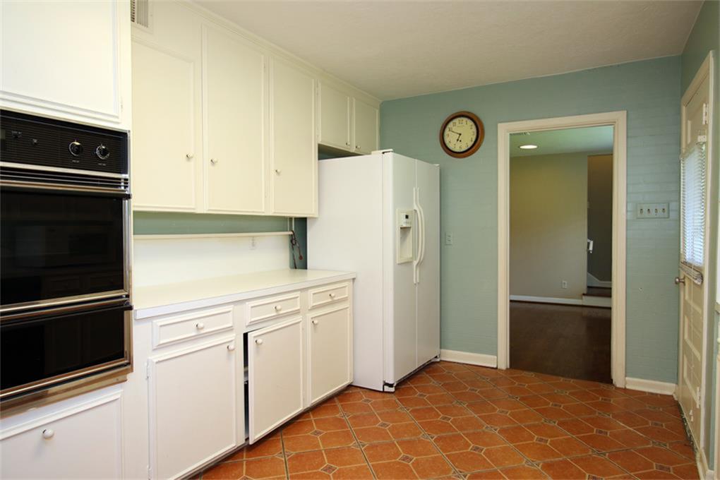 2332 Suffolk Drive Houston, TX 77027 - Photo 9 of 20 a kitchen with a refrigerator and cabinets