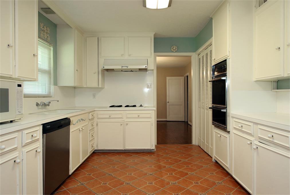 2332 Suffolk Drive Houston, TX 77027 - Photo 10 of 20 a kitchen with white cabinets and appliances
