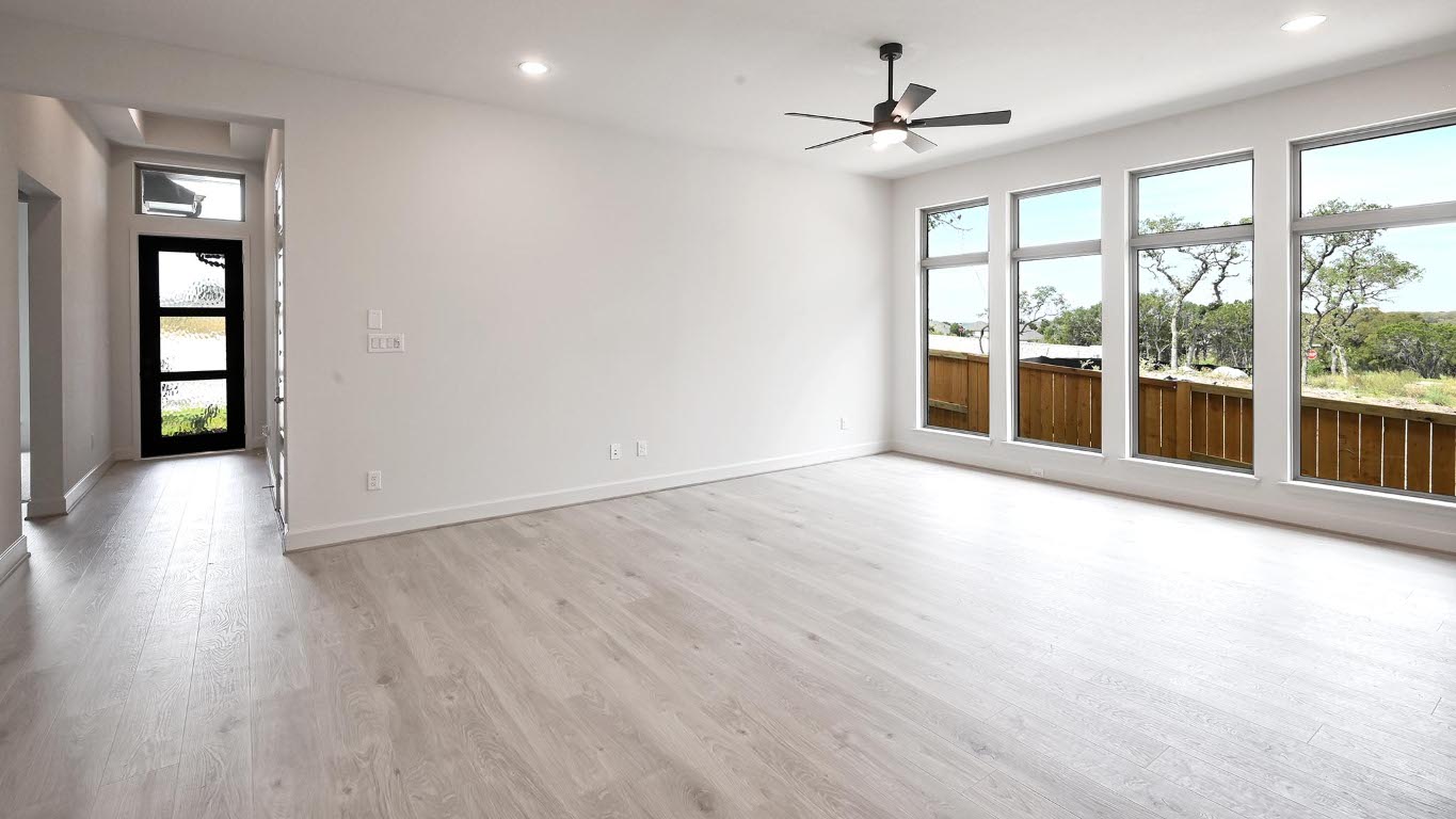 208 High Rock Pass Kyle, TX 78640 - Photo 13 of 40 Unfurnished living room featuring healthy amount of natural light, light wood-style flooring, recessed lighting, and a ceiling fan