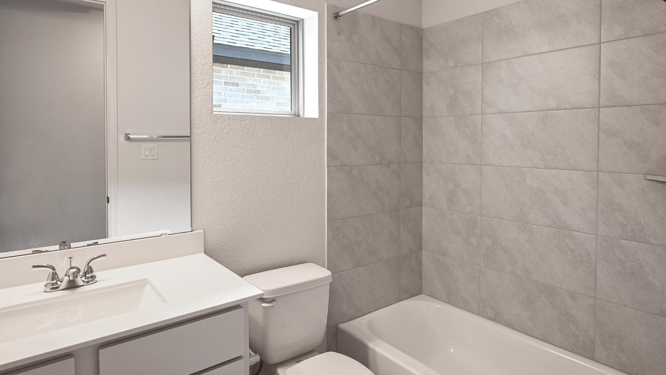 208 High Rock Pass Kyle, TX 78640 - Photo 17 of 40 Bathroom with a textured wall, vanity, and shower / bath combination