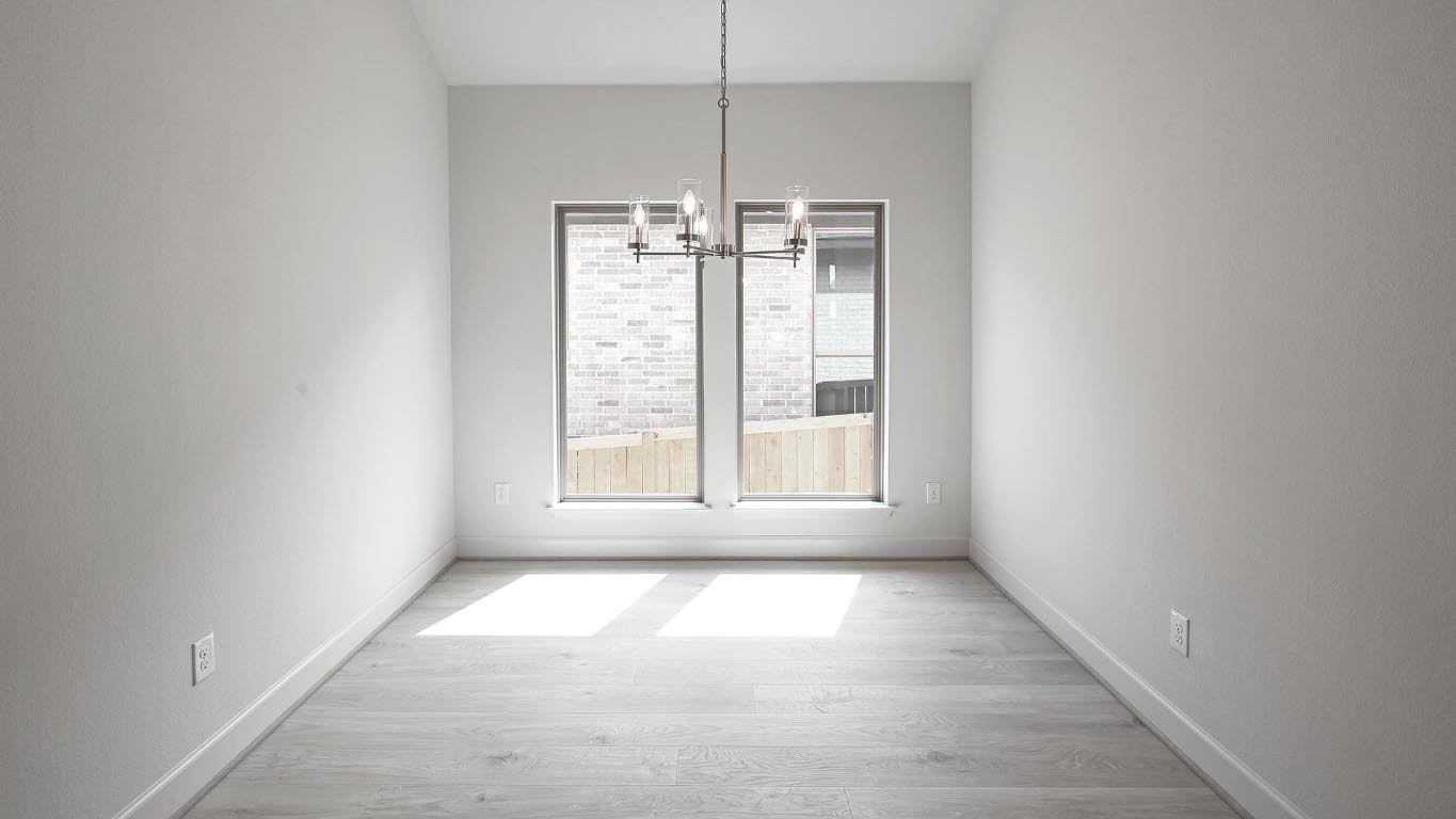 208 High Rock Pass Kyle, TX 78640 - Photo 20 of 40 Unfurnished dining area featuring light wood finished floors and a chandelier
