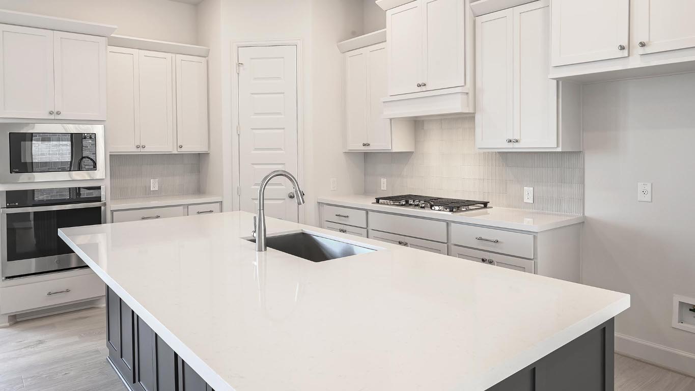 208 High Rock Pass Kyle, TX 78640 - Photo 8 of 40 Kitchen with stainless steel appliances, white cabinets, decorative backsplash, and light stone countertops