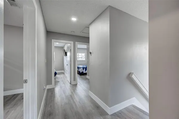 a view of a bathroom with toilet shower and wooden floor