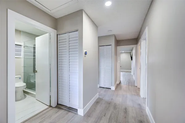 a spacious bedroom with a bed and a window