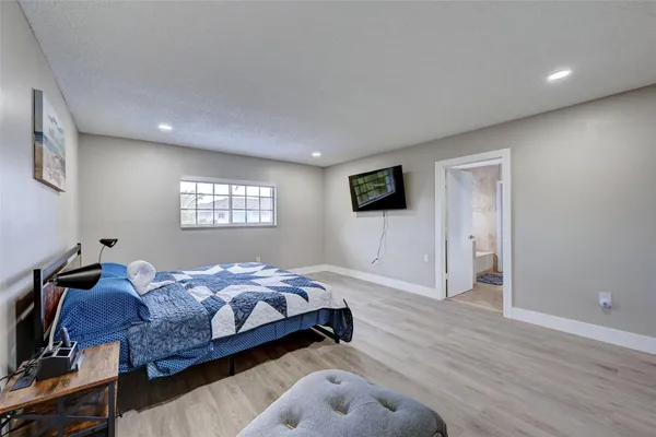 a spacious bedroom with a bed and a couch