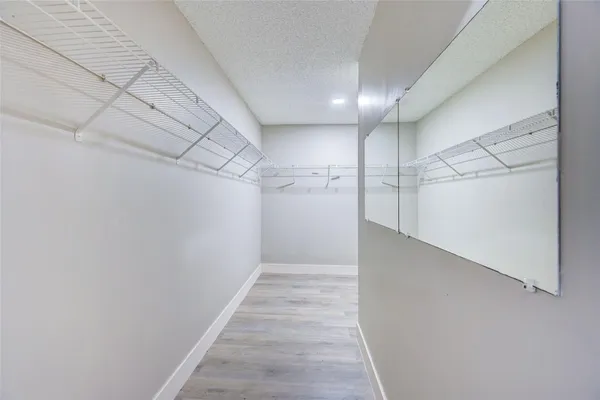 a spacious bathroom with a granite countertop sink and a mirror
