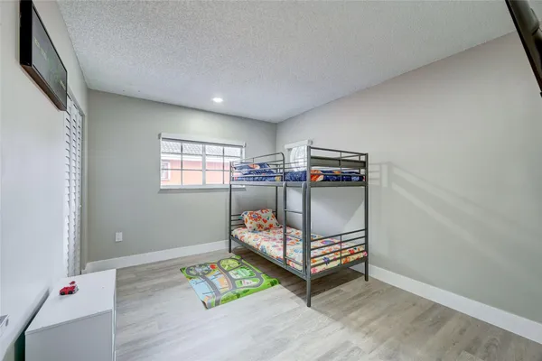 a bedroom with furniture and a wooden floor