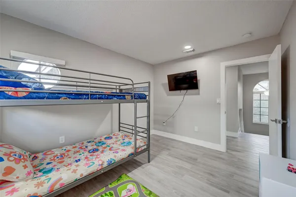 a bedroom with a bed and a tv