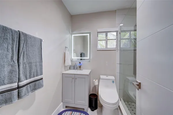a bathroom with a toilet and shower