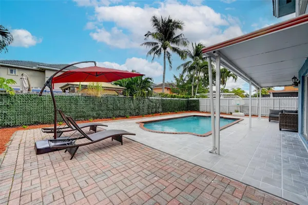 a outdoor living space with patio furniture and potted plants