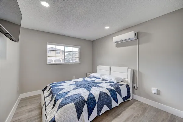 a bedroom with a bed and a mirror
