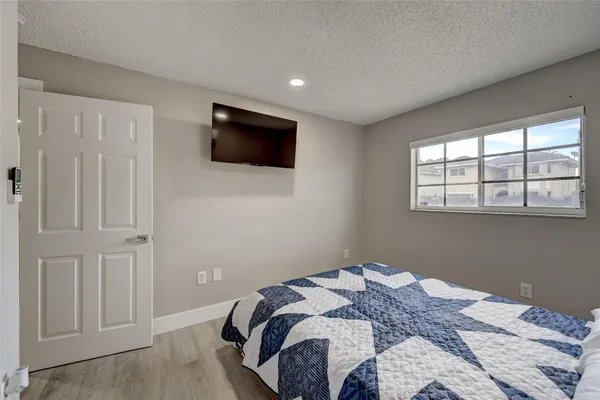 a bathroom with a shower sink mirror and toilet